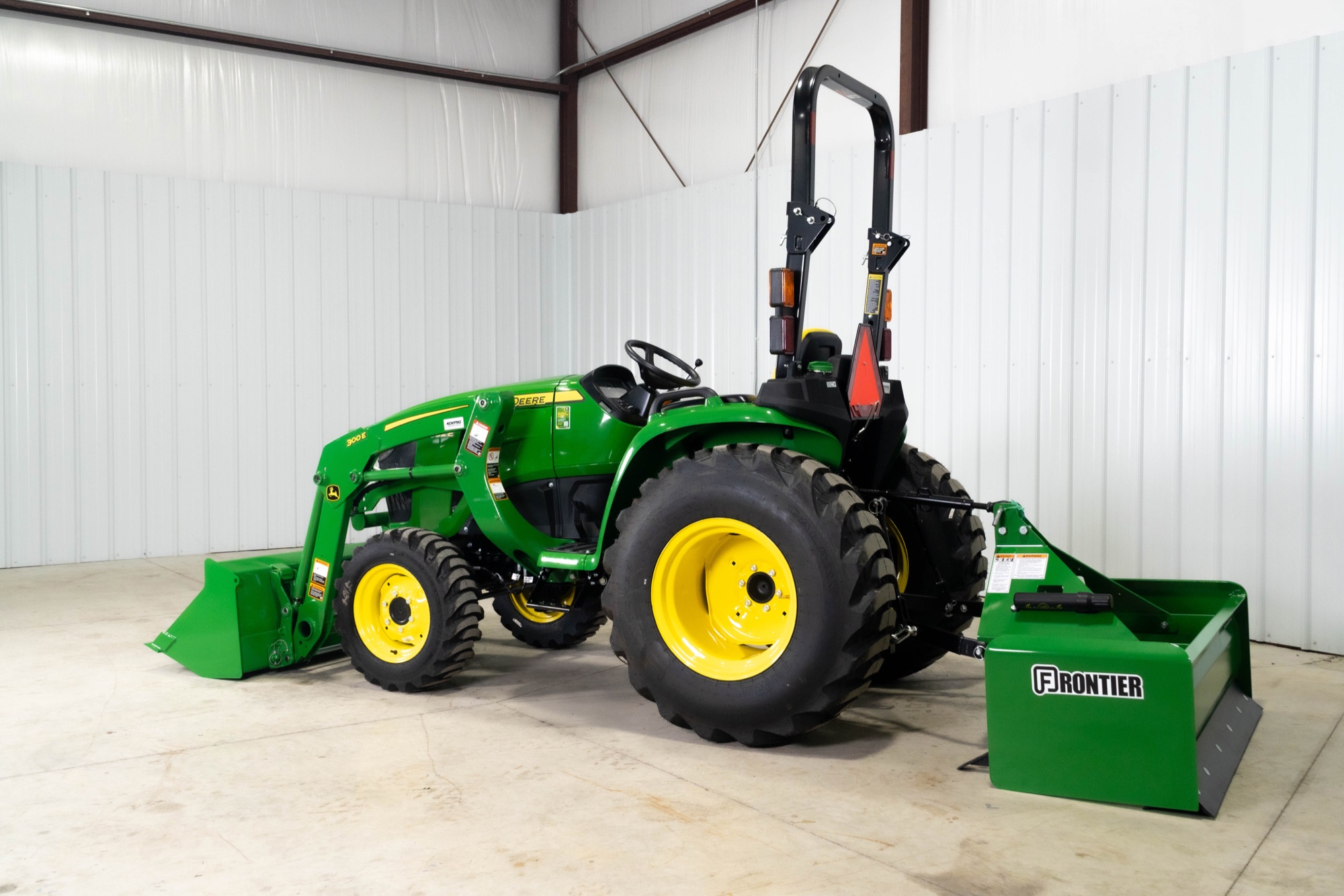 John Deere 3 Series compact tractor with a loader and a Frontier box blade