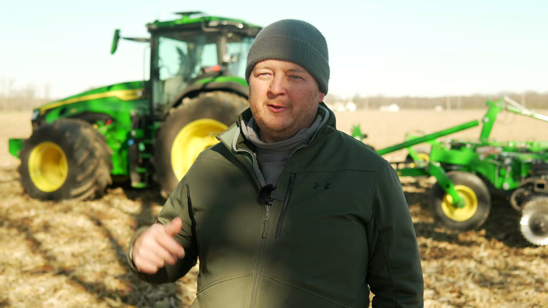 Eric Neer of Neer Farms in a field with a John Deere tractor and tillage tool