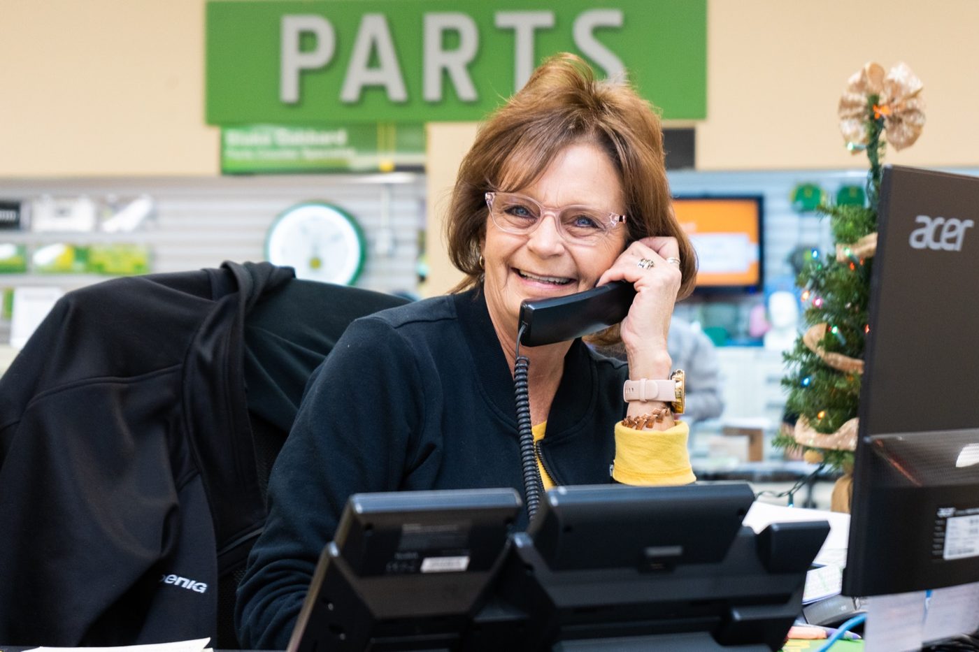 Koenig parts team member taking a John Deere parts call at the parts counter