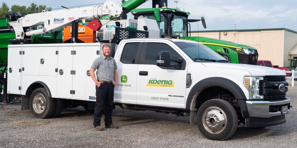 Koenig mobile service technician beside a fully equipped service truck