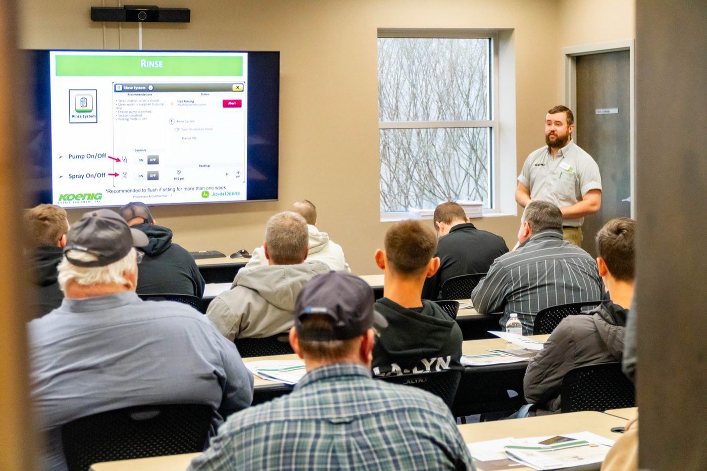 Farmers learning John Deere precision technology from a Koenig specialist at a Precision Ag Academy session