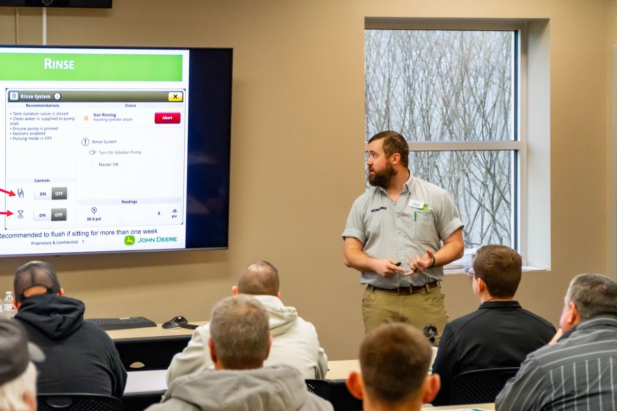 Koenig precision specialist walking farmers through John Deere display setup at a Koenig Precision Ag Academy session