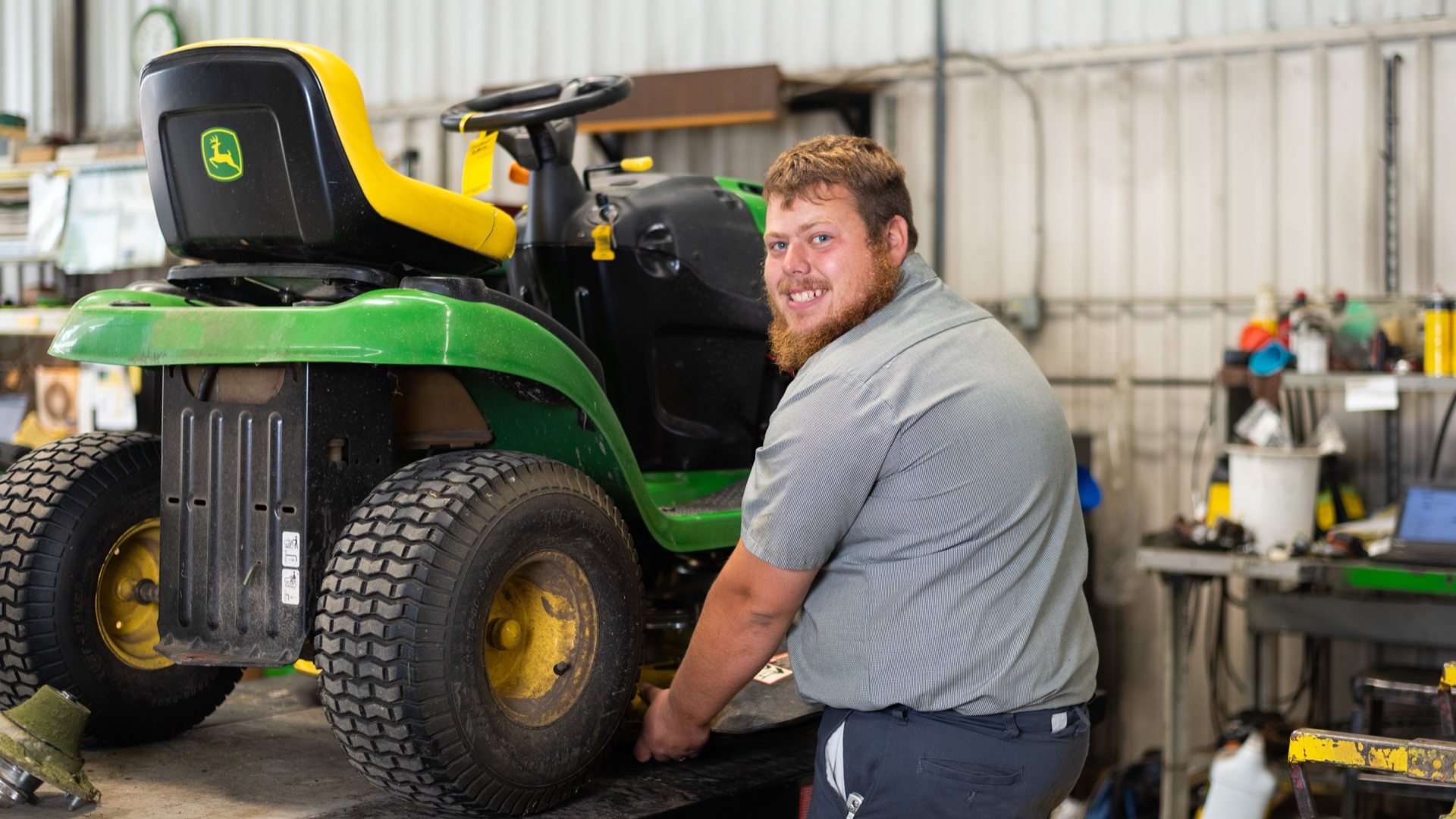 Koenig technician inspecting a John Deere lawn tractor