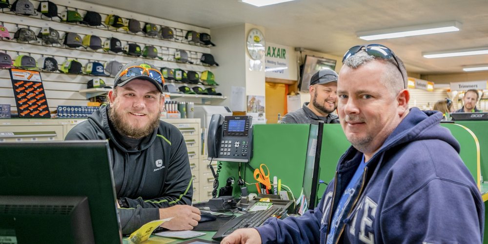 Koenig Equipment team members at the dealership counter