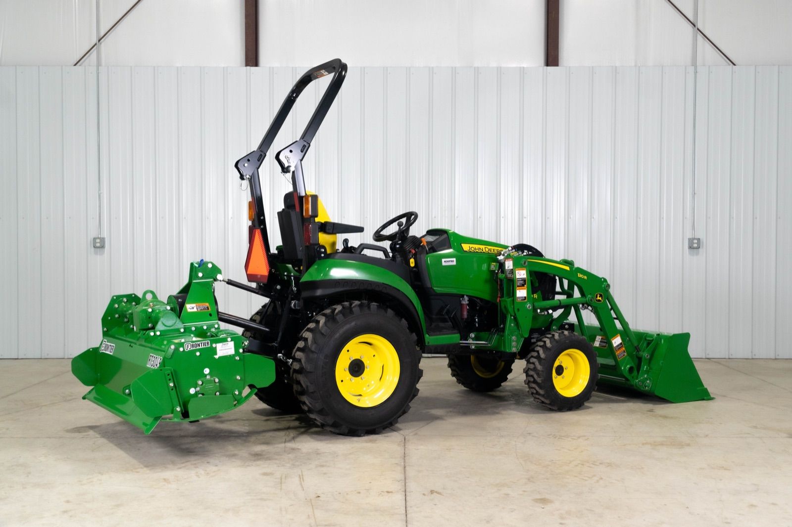 John Deere 2025R tractor with 120R loader and bucket, and RT3049 rotary tiller, from front three-quarter view
