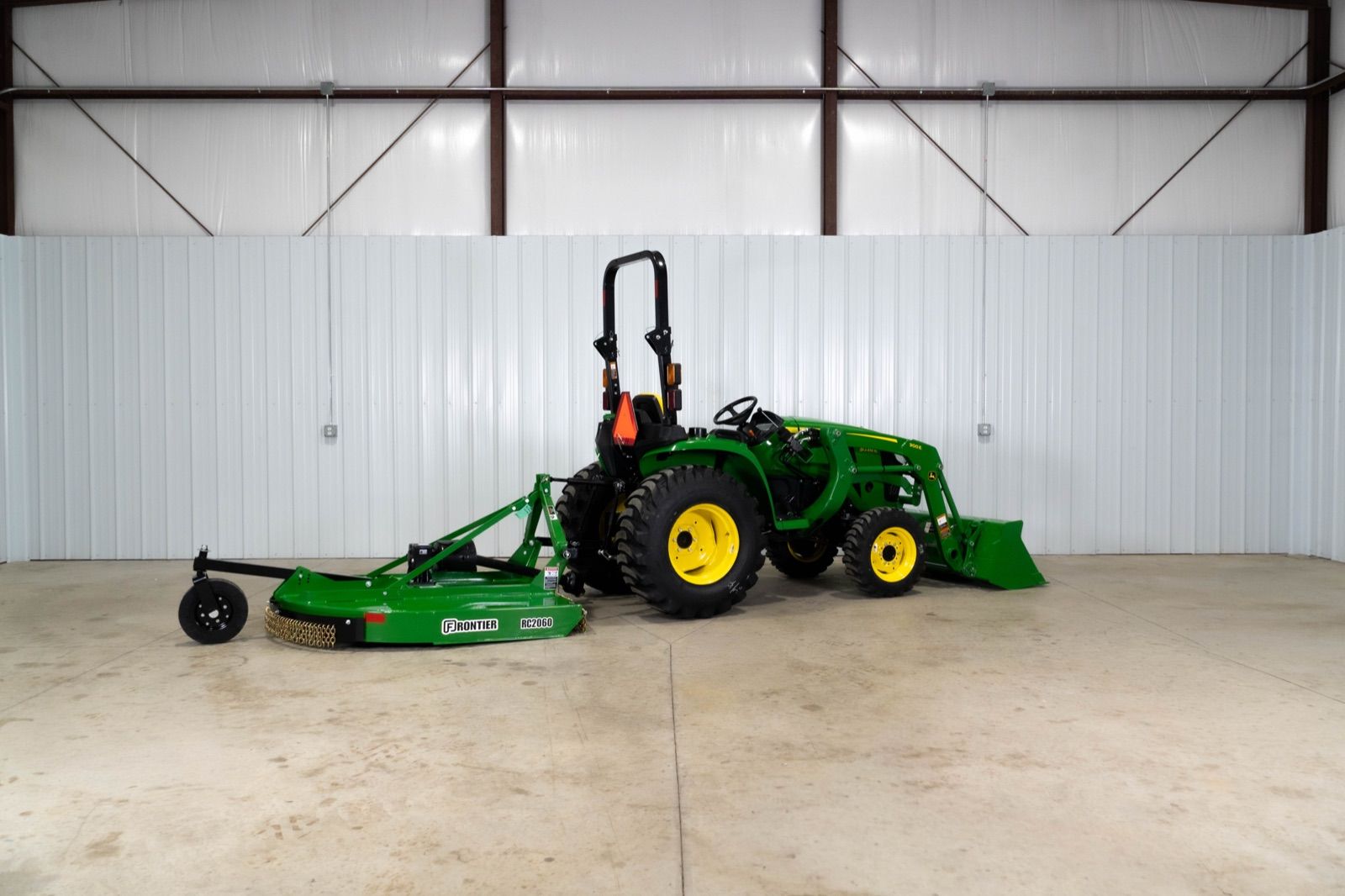 Left side view of the John Deere 3038E tractor with 300E loader and RC2060 rotary cutter