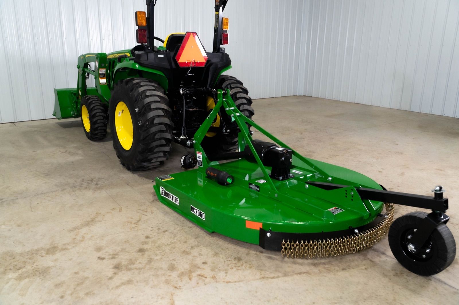 John Deere 3038E tractor with a 300E loader and bucket, and an RC2060 rotary cutter