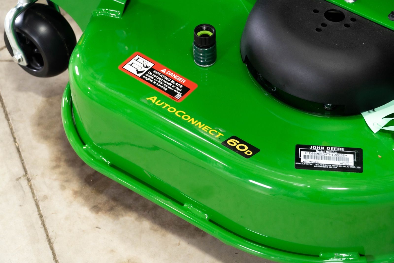 Close-up view of the green 60D mower deck with 'AUTOCONNECT 60D' label on the John Deere 1025R