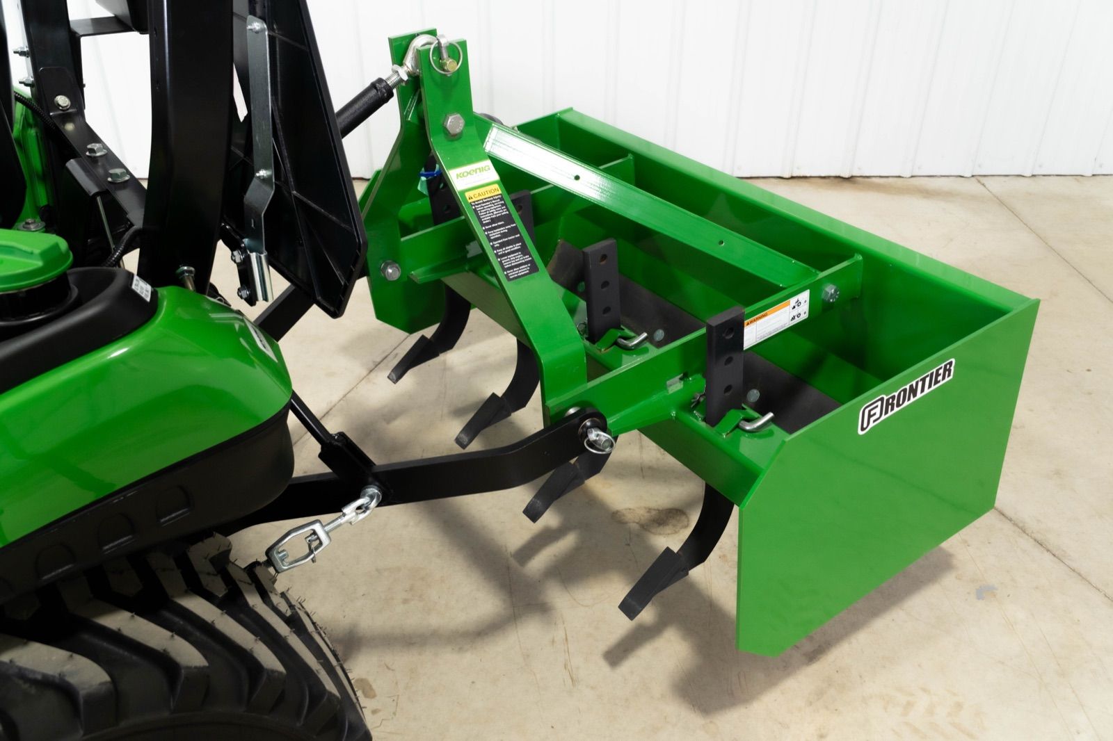 Close-up rear view of the BB5048L box blade attached to the John Deere 1025R tractor