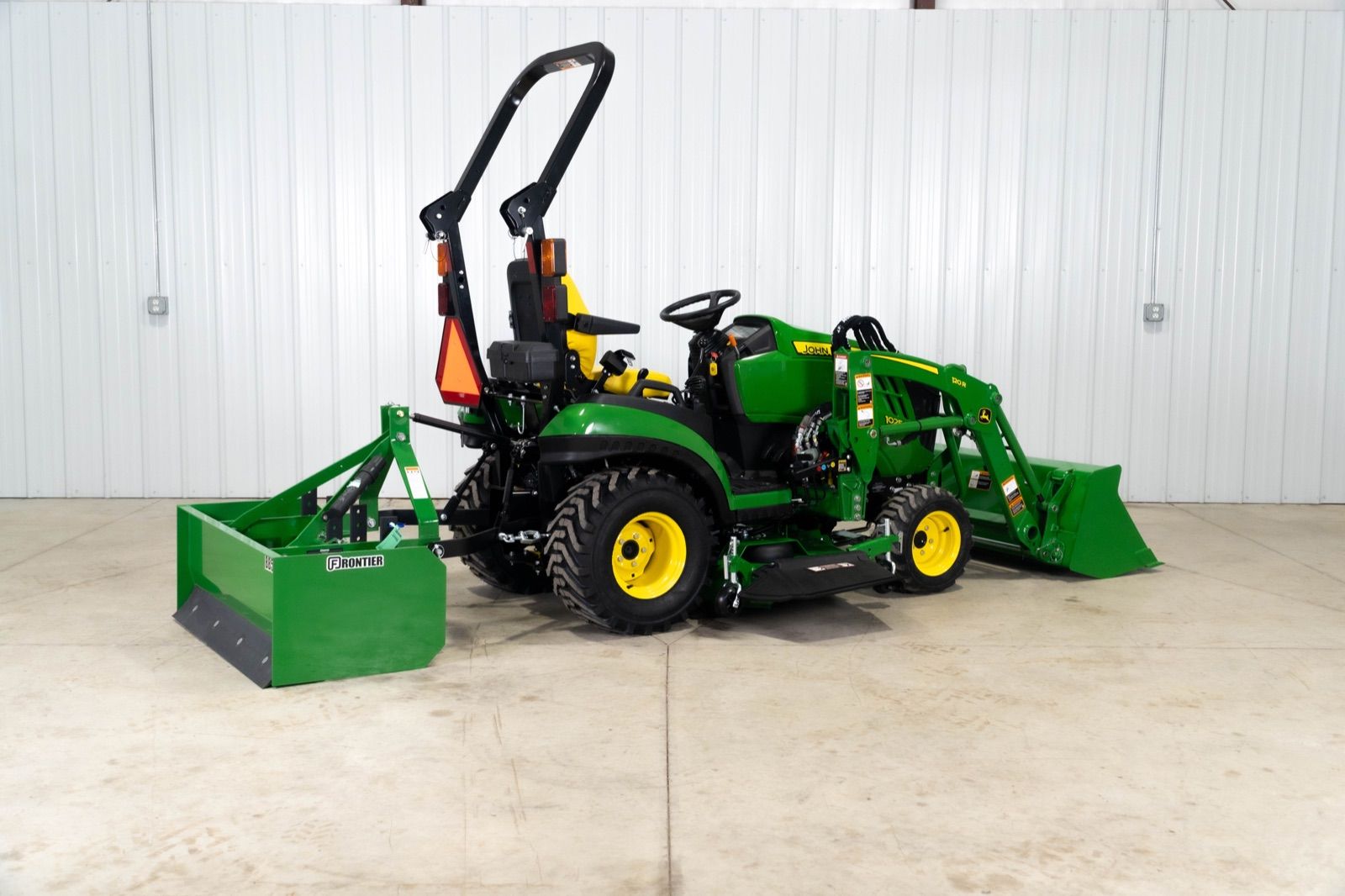 John Deere 1025R tractor with 120R loader and bucket, and BB5048L box blade, from front right