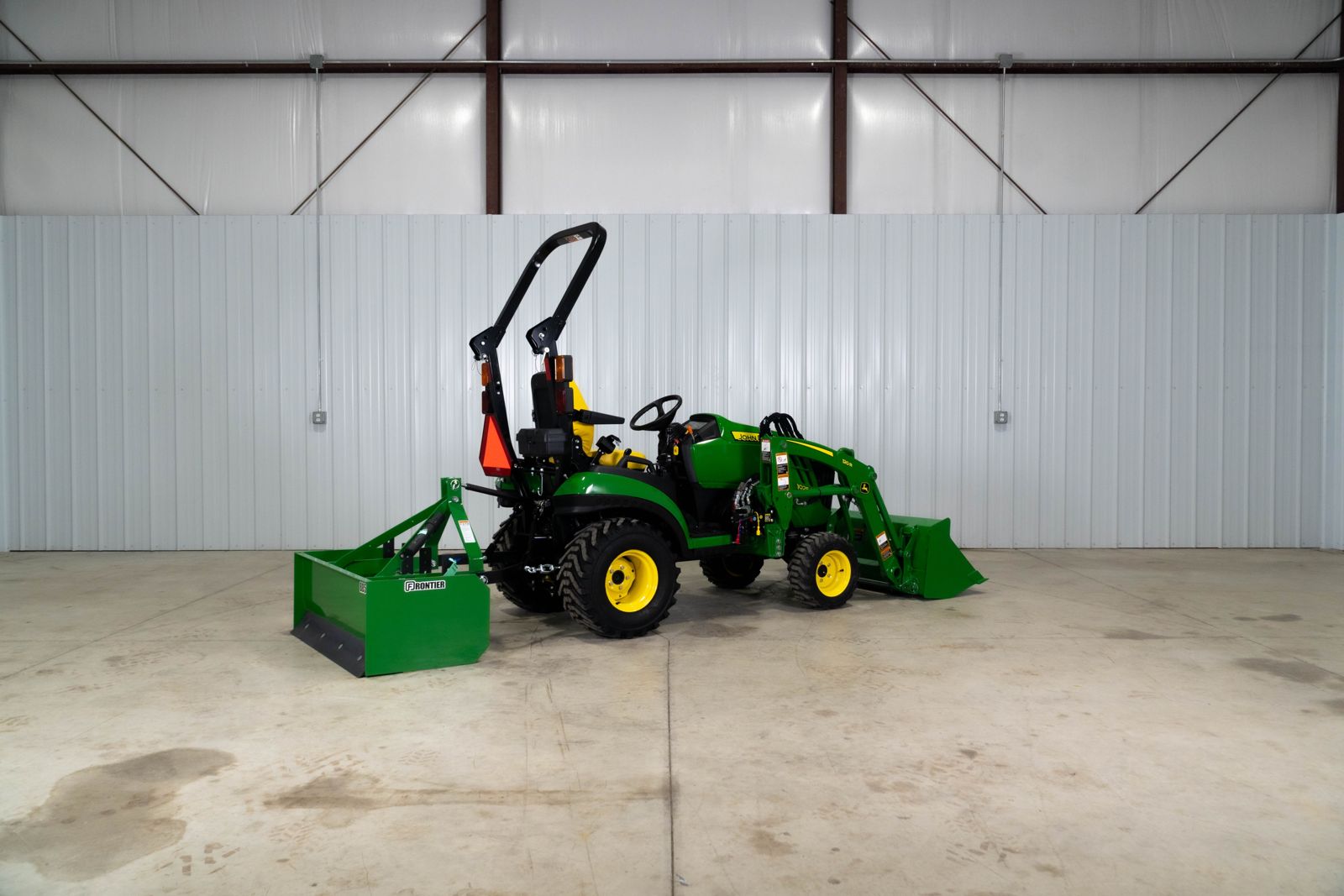 John Deere 1025R Warrior package with 120R loader and BB5048L box blade, left side view