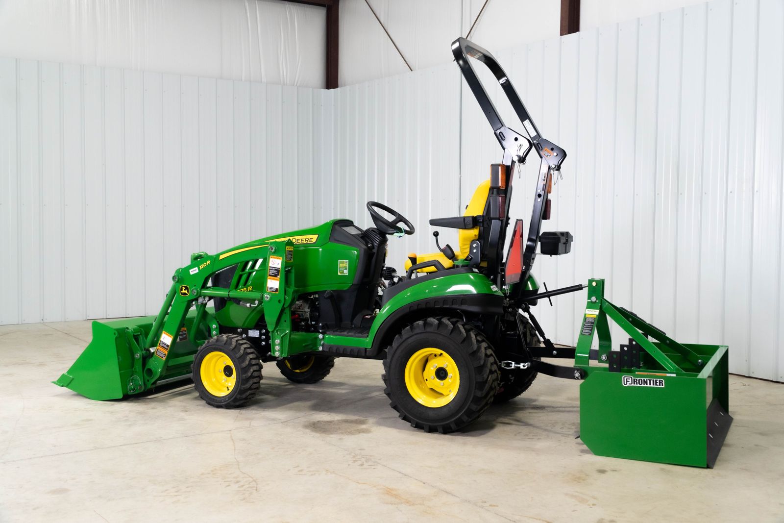 John Deere 1025R with 120R loader and BB5048L box blade on the three-point hitch, right side
