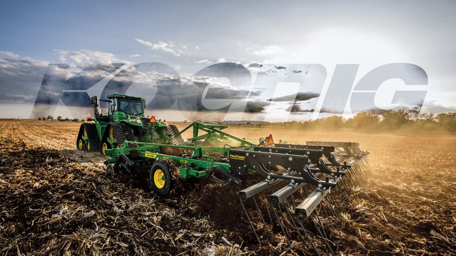 John Deere tractor pulling tillage equipment across a field
