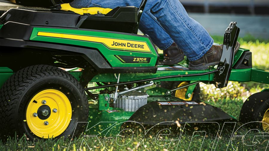 Close-up of a John Deere ZTrak zero-turn mower cutting grass