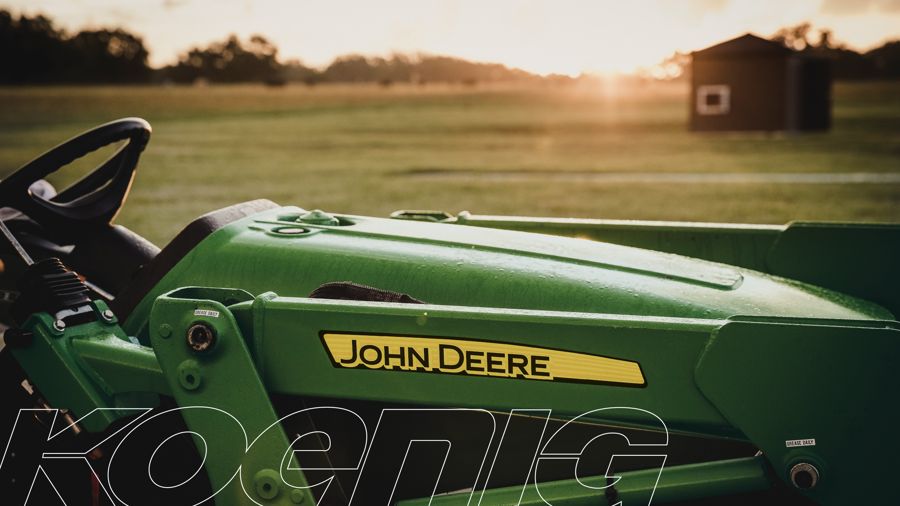 Close-up of a John Deere lawn tractor hood at sunset